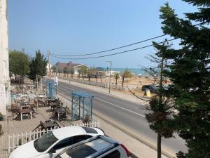 a white car parked on the side of a road at Astara Terrace 2-34 in Astara