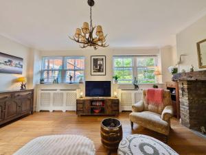 a living room with a fireplace and a television at Stunning House Near Thames With Parking and Garden in Burnham