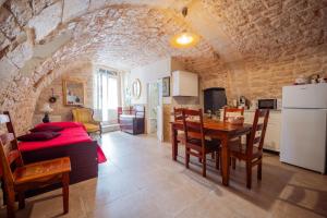 a kitchen and dining room with a table and a refrigerator at Casa Della Nonna - Centro Storico in Conversano