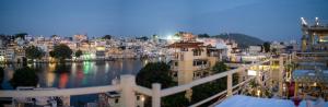 a view of a city with a body of water at DERA PICHOLA- A Lake Facing Boutique Hotel in Udaipur