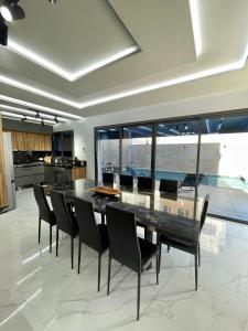 a dining room with a glass table and chairs at Luxury house in Martil in Martil