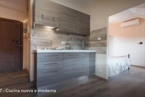 a kitchen with a sink and a bed in a room at New Balon Borgo Dora Center in Turin