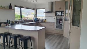a kitchen with a counter and some stools in it at Spacious on Sarita in Cromwell