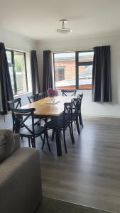 a dining table and chairs in a living room at Spacious on Sarita in Cromwell
