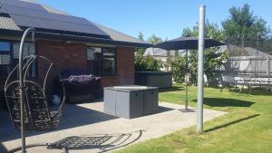 a playground with a swing and an umbrella at Spacious on Sarita in Cromwell