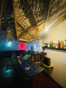 a room with a table and a bar with soda bottles at Walauwa Bungalow in Katugastota