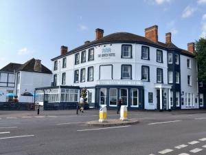 a large white building on the corner of a street at The Beach Hotel in Minehead