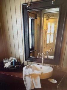 a bathroom with a sink and a mirror at Au coeur de la Vallée in Érezée +25 photos