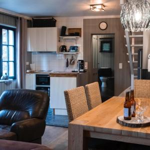 a kitchen and dining room with a table and chairs at Au coeur de la Vallée in Érezée