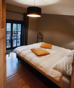 a bedroom with a bed with two pillows on it at Au coeur de la Vallée in Érezée