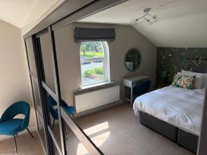 a small bedroom with a bed and a window at Brantwood Cottage in Keldhead