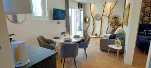 un soggiorno con tavolo, sedie e divano di Romantique chic 150m plage patio a Berck-sur-Mer