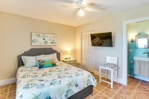 a bedroom with a bed and a ceiling fan at Beachfront Island Condo on Florida Gulf Coast in Placida +25 photos