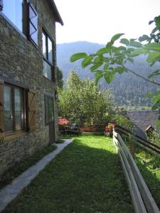 a stone building with a fence next to a yard at Apartamento con jardin en Gessa in Gessa