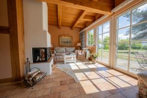 a living room with a fireplace and large windows at Fischerhäuser in Quilitz in Quilitz +31 photos