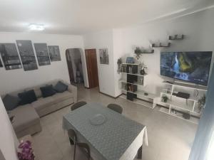 a living room with a couch and a table at Tavira sweet home in Tavira