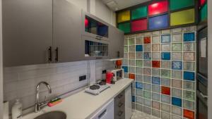 a kitchen with colorful tiles on the wall at Balat Side Apart in Istanbul +126 photos