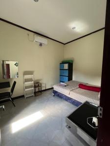 a bedroom with two beds and a sink in it at Parkside nest-studio 3 in Kuta Lombok +5 photos