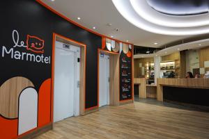 a restaurant lobby with a marmite sign on the wall at The Originals Boutique, Hôtel Le Marmotel, Clermont-Ferrand in Clermont-Ferrand