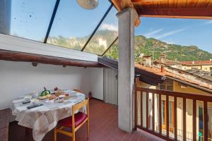 a table and chairs on a balcony with a view at La Mansarda del Viaggiatore in Pont-Saint-Martin