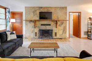 a living room with a large stone fireplace at Vacation Home Rental in Gainesville, Florida! in Gainesville