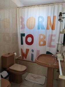 a bathroom with a toilet and a shower curtain at House Rural,Biosphere Reserve World.Taganana.Tfe. in Santa Cruz de Tenerife