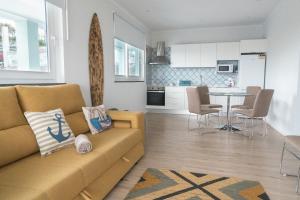 a living room and kitchen with a couch and a table at Villas da Salga in Angra do Heroísmo