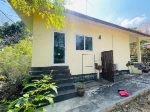 a house with a red bag in front of it at Jungle Breeze Bungalow, Fast WiFi, Quiet Retreat in Ban Dan Mai