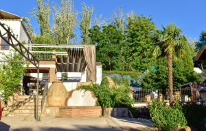 a house with a fence and a palm tree at Casa Rural Arados in Priego de Córdoba