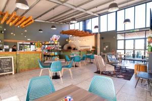 a restaurant with chairs and tables in a cafeteria at #AlimamaSpaces Manson's Fynbos Villa in Cape Town