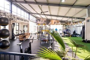 a gym with a lot of exercise bikes and a plant at #AlimamaSpaces Manson's Fynbos Villa in Cape Town