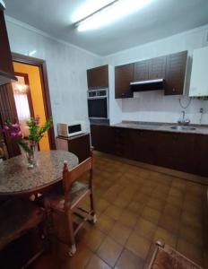 a kitchen with a table and a counter top at Piso Asturias Centro in Langreo