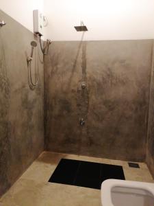 a bathroom with a urinal and a sink at Sunshine Forest Lodge - Sinharaja in Deniyaya +78 photos