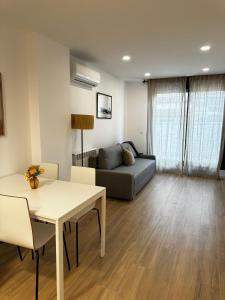 a living room with a couch and a table at VTZ Los Balcones del Casco in Zaragoza +33 photos