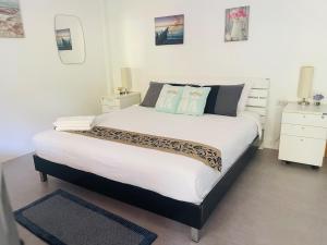 a bedroom with a large white bed with two pillows at Jungle Breeze Bungalow, Fast WiFi, Quiet Retreat in Ban Dan Mai