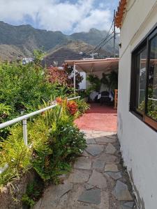 a house with a patio with mountains in the background at House Rural,Biosphere Reserve World.Taganana.Tfe. in Santa Cruz de Tenerife