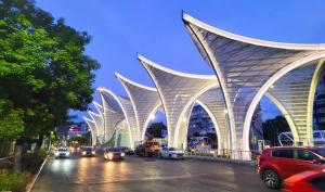 a building with a curved roof on a city street at Apartament nou si modern lanaga metrou in Bucharest