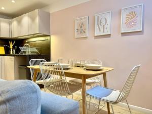 a dining room with a wooden table and chairs at Appart Cosy Hypercentre in Lille +26 photos