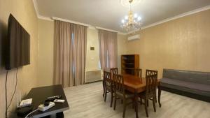 a living room with a table and chairs and a couch at Panorama City Kutaisi in Kutaisi