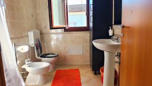a small bathroom with a toilet and a sink at Residence MARISOL in Cesenatico