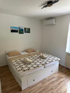 a bedroom with a white bed with two ducks on it at Apartment Tonc in Kobarid