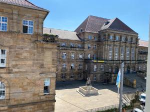 a large building with a statue in front of it at Modernes Apartment no5 in bester Stadtlage in Kassel