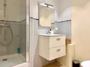 a white bathroom with a shower and a sink at Appart Cosy Hypercentre in Lille