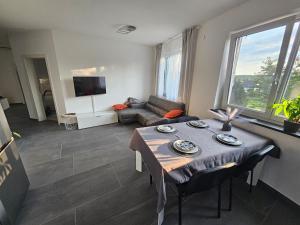 a living room with a table and a couch at Legola in Bubesheim