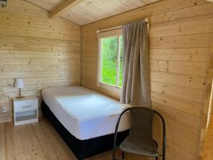 a small bedroom with a bed and a window at Búdardalur glamping in Búðardalur
