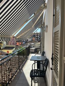 a balcony with a table and chairs on a building at The loft in Carpaneto Piacentino