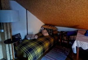 a bedroom with a bed with two stuffed animals on it at Puķkalniñš in Ventspils