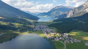 an aerial view of a village on the shore of a lake at AquaVista Lakeside Apartments in San Valentino alla Muta +9 photos