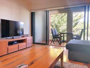 a living room with a large flat screen tv at The Iceworks-overlooking Esplanade W Parking 2 Carscentral in Fremantle