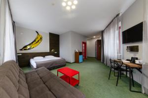 a hotel room with a couch and a banana on the wall at Emigrand Art Hotel in Uzhhorod